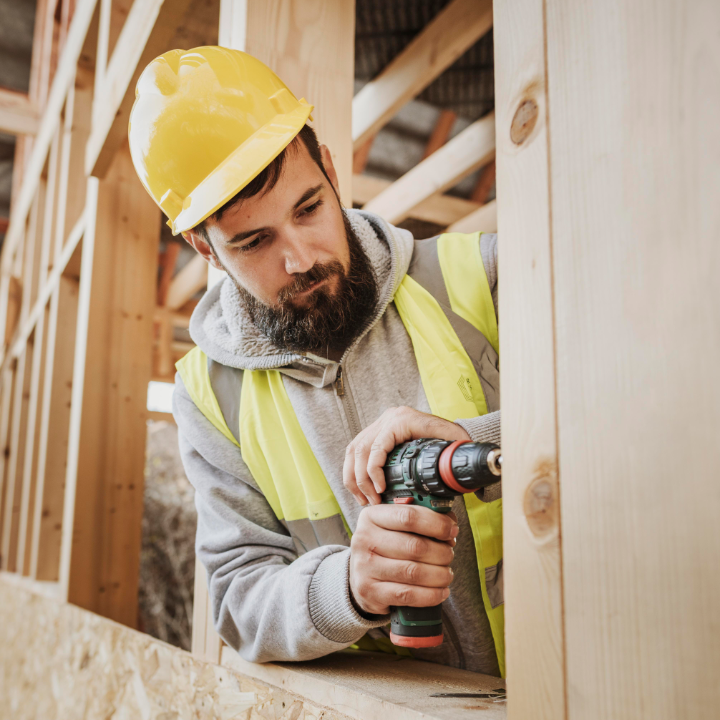 MAN WORKING ON FRAMING